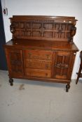 An early 20th Century oak sideboard having panel ledge back