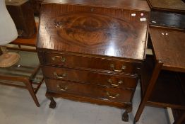 An early 20th Century mahogany bureau on cabriole legs and ball and claw feet