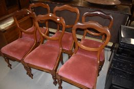 A set of six Victorian mahogany balloon back dining chairs having shaped backs and turned frames