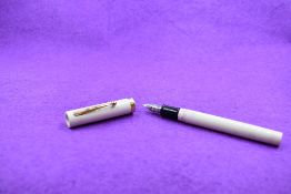A Sheaffer cartridge fountain pen in cream with broad band to cap having a Sheaffer Italic F nib.