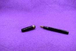A Mabie Todd & Co Swan Leverless twist filler, in black with diamond pierced decorated broad band to