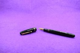 A Mabie Todd & Co Swan 3240 Self Filler Leverfill, in dark green with two bands to the cap and a