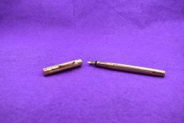 A Mabie Todd and Co Ltd Swan Fountain pen, in 14ct gold (cap and barrel marked 14 585) with engine