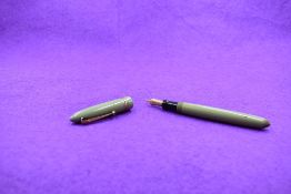 A Mabie Todd & Co Swan Leverless twist filler, in sage green with two narrow and one broad band to