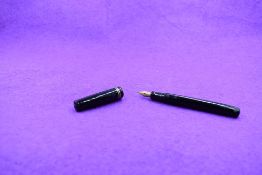 A Mabie Todd & Co Swan L112/60 Leverless twist filler, in black with two bands to clipless cap and a