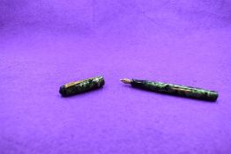 A Unique fountain pen in green marble with two narrow gold bands to cap, leverfill with 14ct gold