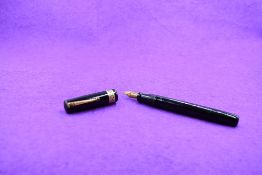 A Mabie Todd and Co Swan Visofil fountain pen in black with broad decorative band to cap having a