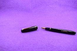 A Mabie Todd & Co Swan 6261 Self Filler Leverfill, in black with two bands to the cap and a Swan No2