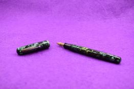 A Watermans Ideal Junior leverfill fountain pen in Green marble with single narrow band to cap and