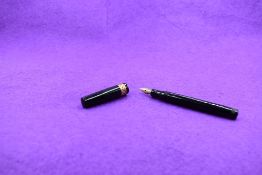 A Mabie Todd & Co Swan Leverless twist filler, in black with diamond pierced (over red) decorated