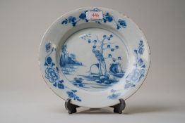 A late 18th century blue and white wear English delft plate decorated with a Chinoiserie style
