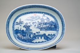An antique hard paste Chinese export serving dish or charger having a hand decorated blue and