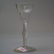 A wine glass, circa 1750 on plain foot with air twist stem central knop and ogee bowl.