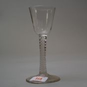 A circa 1750 wine glass having plain foot and stem with multi opaque spiral twist and plain bowl.