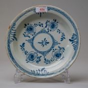A late 18th century English delft plate or soup bowl in traditional blue and white design with