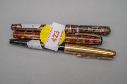 Three desktop fountain ink pens, one by Parker having metal cased cap, a Conway Stewart no.88 with