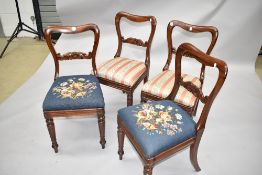 A set of four Victorian baloon back chairs having scroll rails, two with woolwork seats, two with