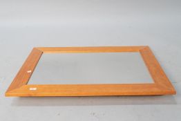 A modern pine wall mirror, approx. 92 x 67cm