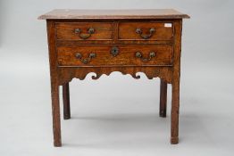 A 19th Century mahogany lowboy having two short over one long drawer, shaped apron and square