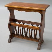 A modern hardwood magazine table having spindle under rack and floor protectors on feet