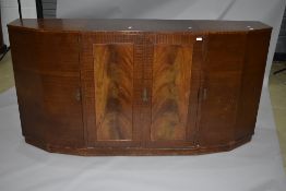 An early to mid 20th Century sapele sideboard having stepped design, with central double cupboard