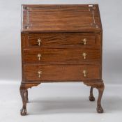 A traditional stained frame bureau , carved and cockbeaded detailing to flap , three drawers to base