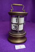 A 1930's desktop flip ticket clock by Ever Ready the Chronos Clock having glass and brass case