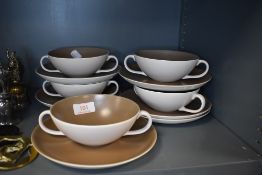 A selection of soup cups and saucers by Poole pottery having pink and cream colourways