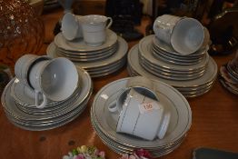 A porcelain part tea and dinner service in a white ground with gilt detailing