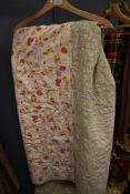 A large vintage quilt having floral section used throughout and backed in white cotton.