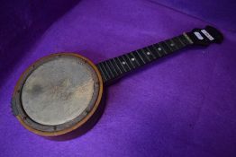 A folk art style banjo/ukulele