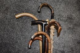 A selection of antique and later walking sticks canes and sticks including HM silver marked