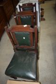 A set of three Victorian mahogany chairs having green leather seats and backs, possibly from a