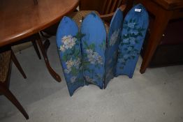 A traditional Gothic style four fold fire screen having painted decoration