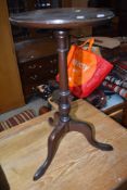 A 20th Century mahogany wine table having circular top , turned column and triple splay legs