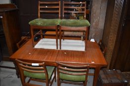 A vintage G plan or similar teak extending dining table with integral butterfly style centre leaf,