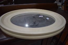 A modern oval wall mirror , approx. 54 x 44cm