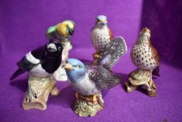 Five Beswick figure studies of birds, Parakeet 930, Song thrush 2308, Cuckoo 2315, Magpie 2305 and