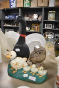 A Poole pottery owl signed by Barbara Linley Adams and two cast duck doorstops.