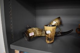 Two bovine cow or similar horns and a similar stirrup cup