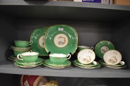 A fine bone China part tea service by Chelson in a green ground with fine enamel and gilt detailing