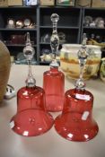 Three cranberry glass door or dinner bells