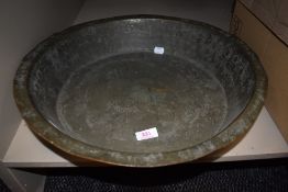 A large copper basin with twin handles