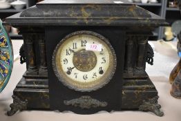 A Victorian gothic cased mantle clock having an enamel and ormolu face