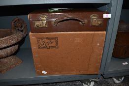 A small leather briefcase with fitted interior and a similar box