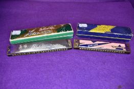 Two musical harmonicas including Echo Luxe M Hohner and Hero both with cases