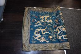 A large Chinese wall hanging embroidery on green silk depicting nine dragons in gold thread 220cm