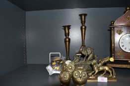 A selection of brass wares including mythical griffin, pair of candle sticks and owls