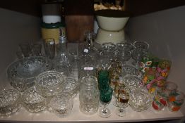 A selection of clear cut and crystal glass wares including spirit glasses and transfer printed