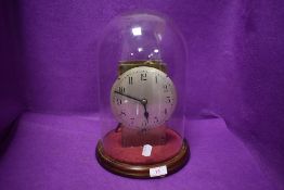 A late Victorian glass dome housing a hand made skeleton clock 33cm high by 20cm wide approx